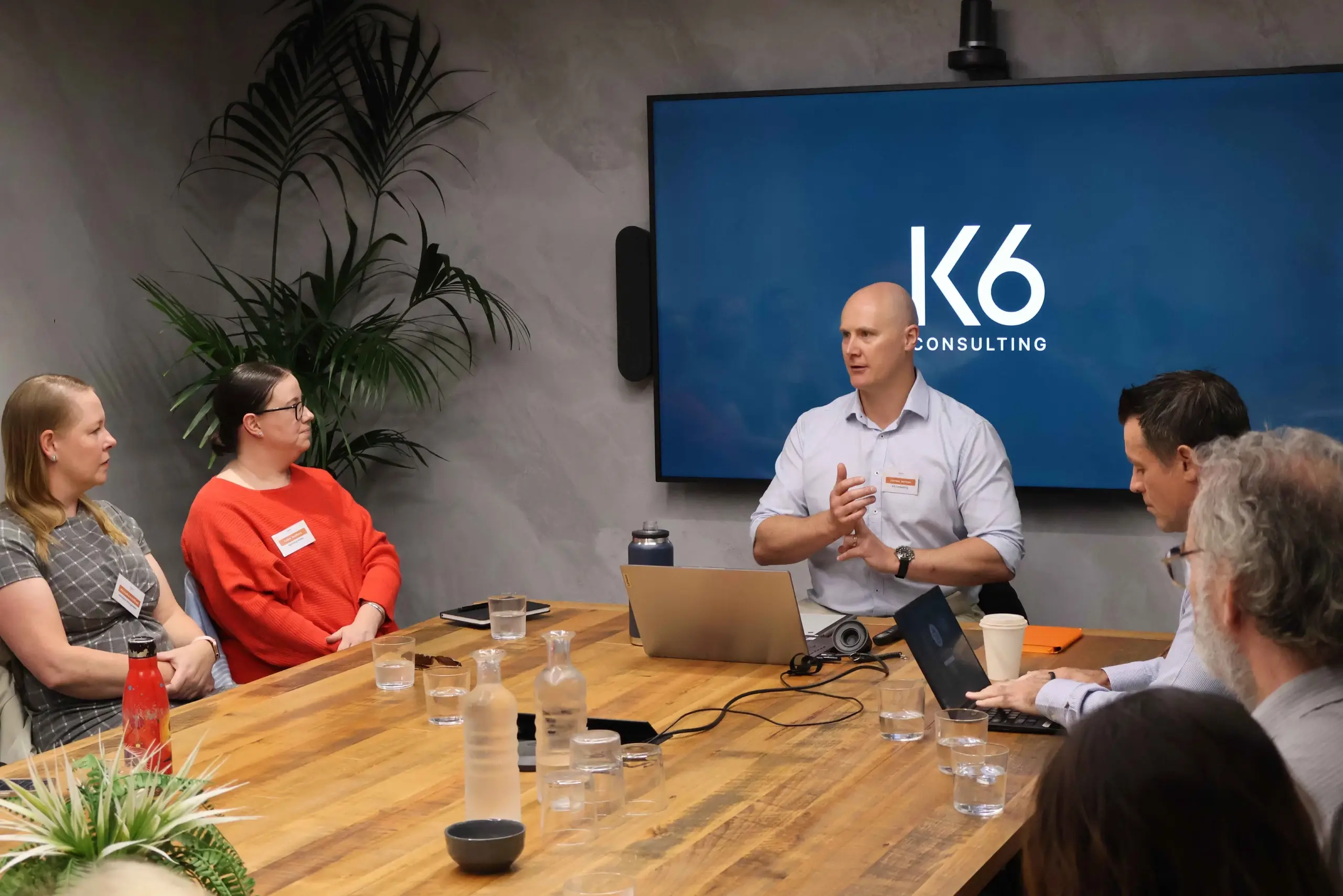 James Jensen taking class around office desk
